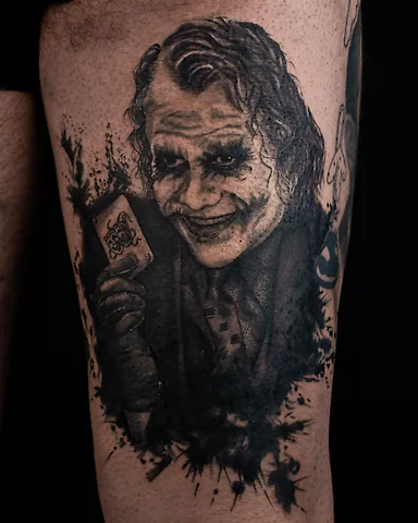 Realistic black and grey Heath Ledger Joker portrait thigh tattoo, by Domi (based in Coventry, UK)