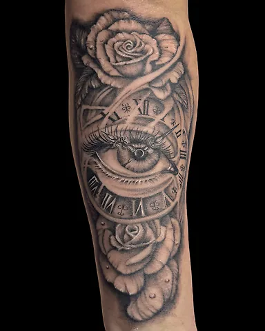 Realistic black and grey eye, clock and roses forearm tattoo, by Domi (based in Coventry, UK)