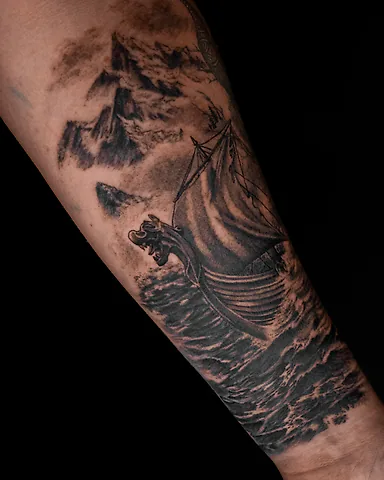 Black and grey Viking longship and stormy sea forearm tattoo, by Domi (based in Coventry, UK)