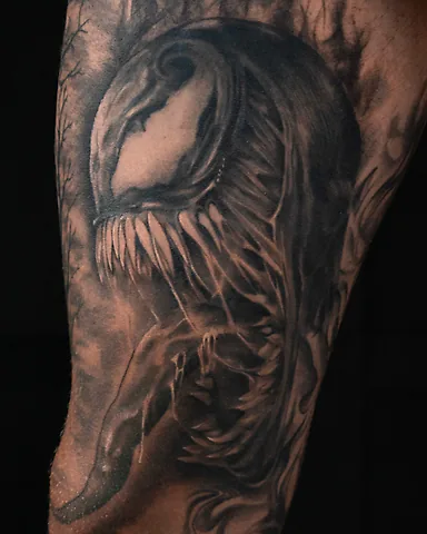 Realistic black and grey Venom (Marvel) portrait thigh tattoo, by Domi (based in Coventry, UK)